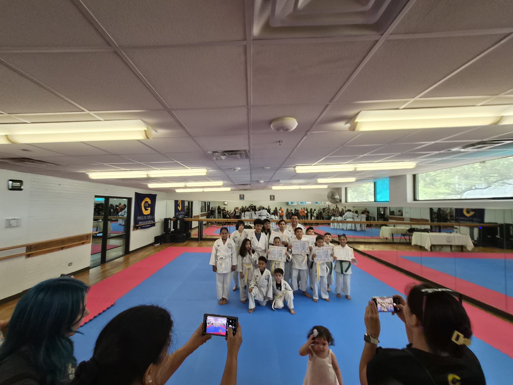 Families photographing a group of dojo students
